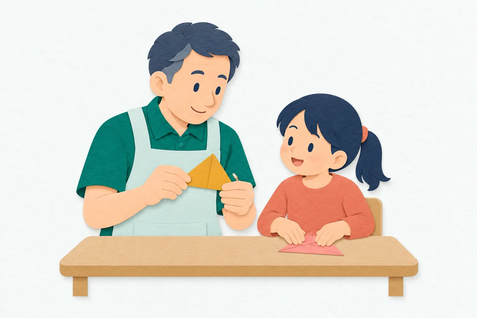 幼稚園で、男性の教諭が子どもの隣に座り、折り紙の形を示しながら制作活動を見守っている。